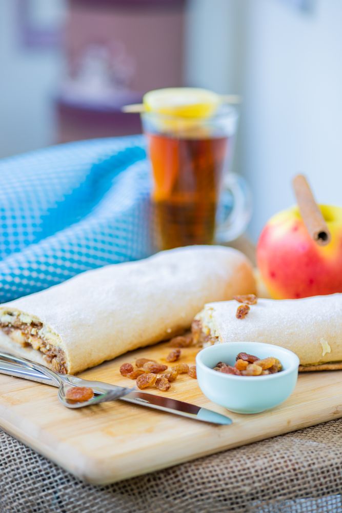 Apple strudel with cup of tea in background