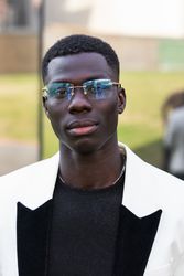 Stylish Black businessman in eyeglasses in town