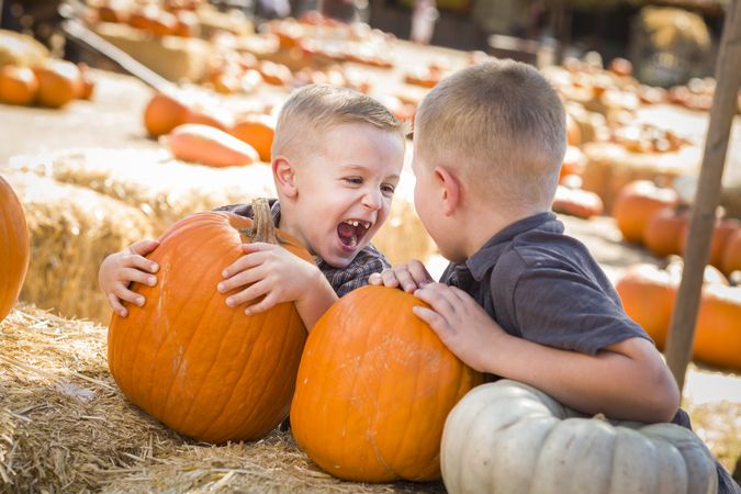 Two Boys at the Pumpkin Patch Talking and Having Fun.