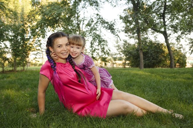 Woman and girl sitting in city park