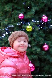 Excited child standing with a decorated holiday tree 5ldwm5