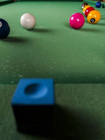 Blue pool chalk on billiard table