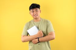 Young Asian man Holding Tablet Computer