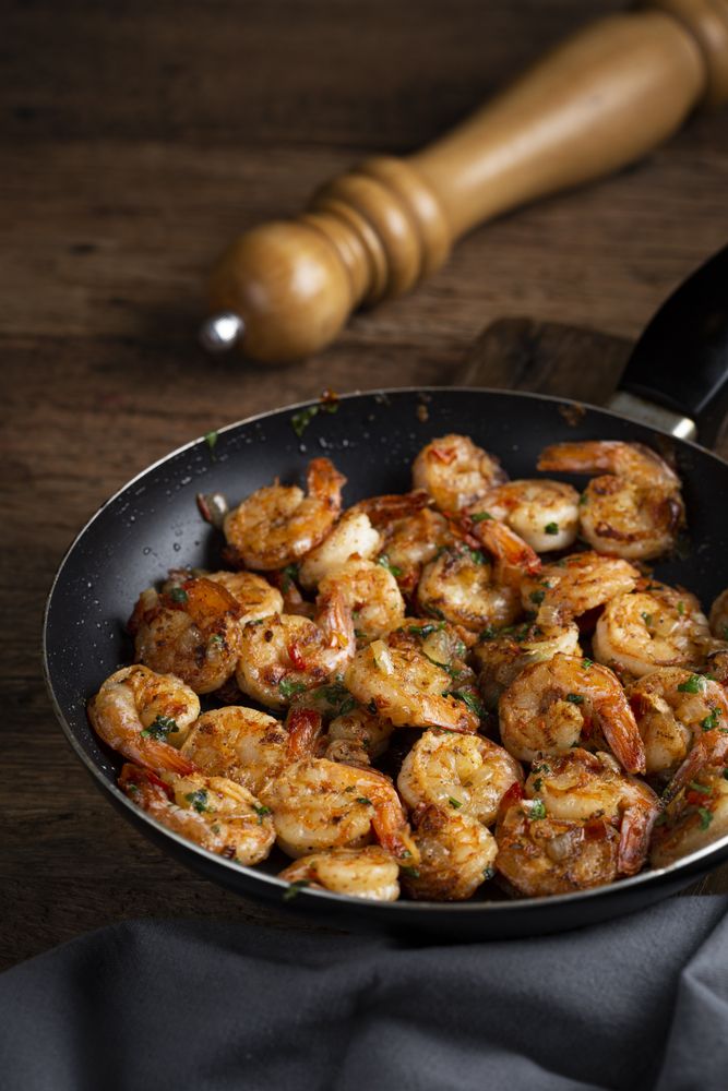 Delicious grilled prawns on wooden background.