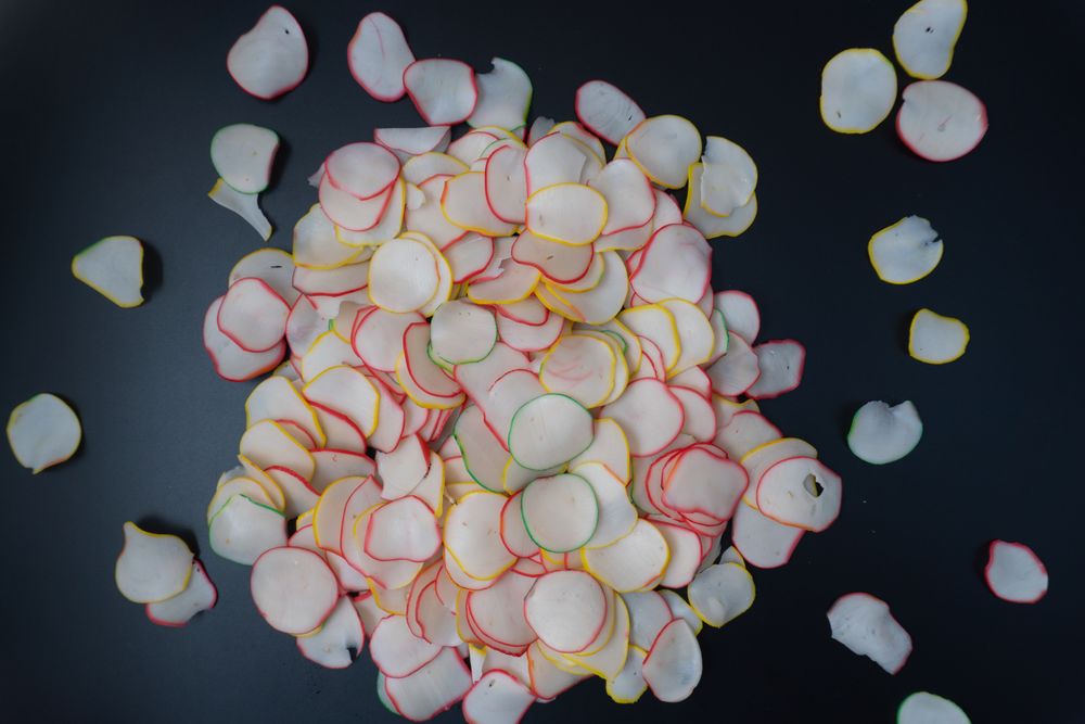 Thinly sliced, dried raw crackers ready to be fried