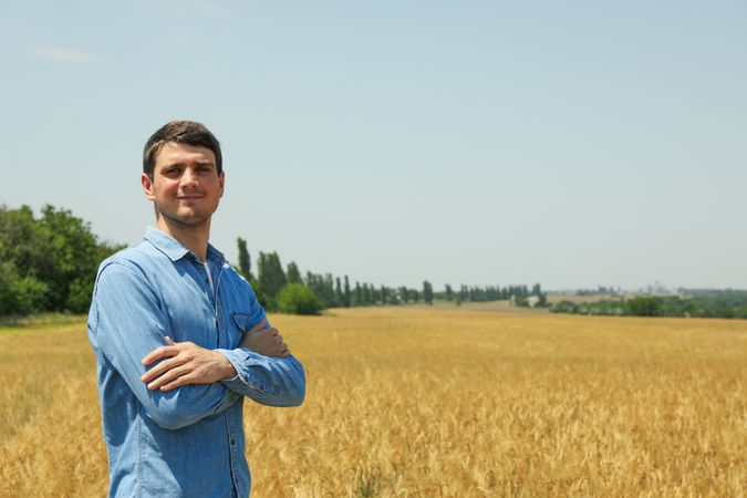 Young man in barley field. Agriculture business. Farming