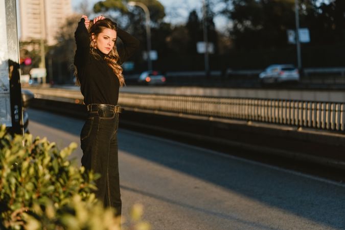 Cheerful woman hailing taxi