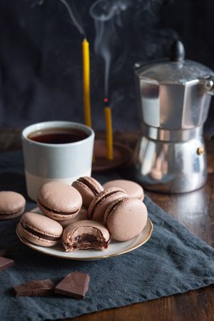 Homemade chocolate macarons on wooden table