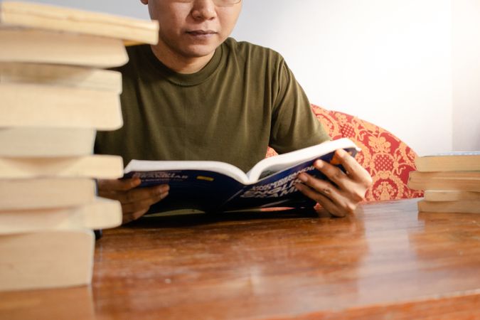 Asian young student study, reading and writing sit on sofa at living room
