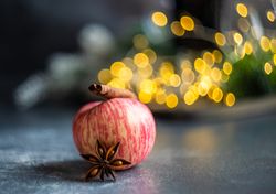 Apple on table with star anise and cinnamon stick