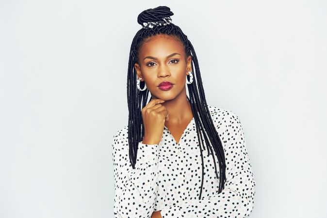 Studio portrait of confident woman with a serious expression