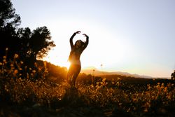 Woman walking on meadow and enjoying freedom