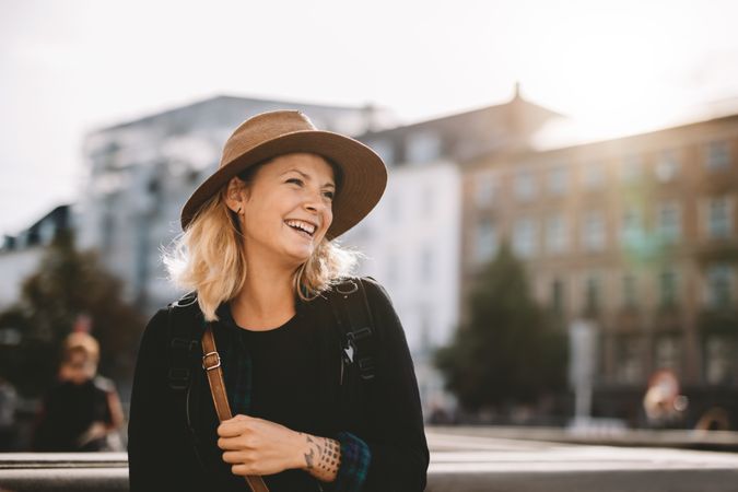 Smiling female tourist wearing hat