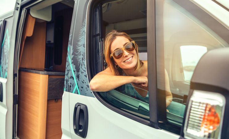 Female passenger in motorhome leaning out window