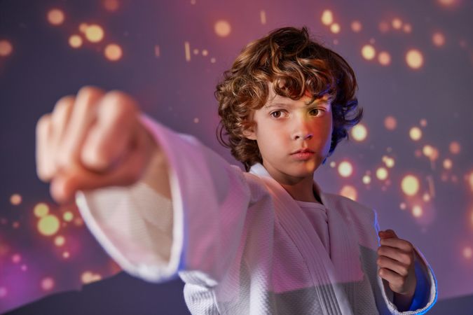Boy practicing punch during judo training