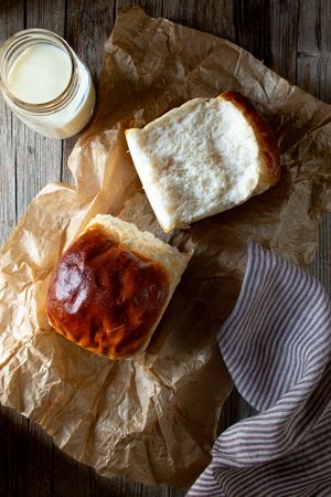 Fresh bread and milk near napkin