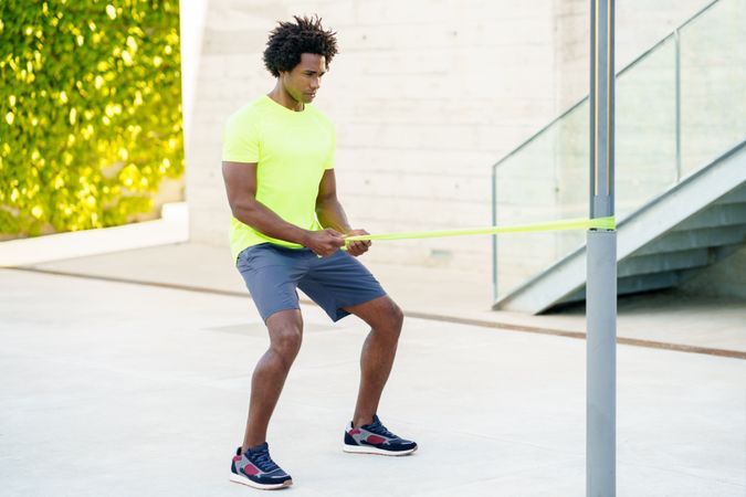 Man working out with resistant bands outside