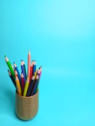 colored pencils on a light blue background with a back to school theme