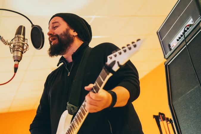 Musician playing guitar and singing