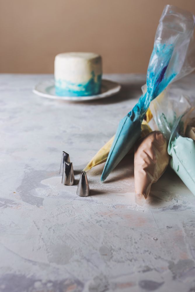 Cake decoration -pastry bags filled with full frosting color, and stainless pipping nozzles,