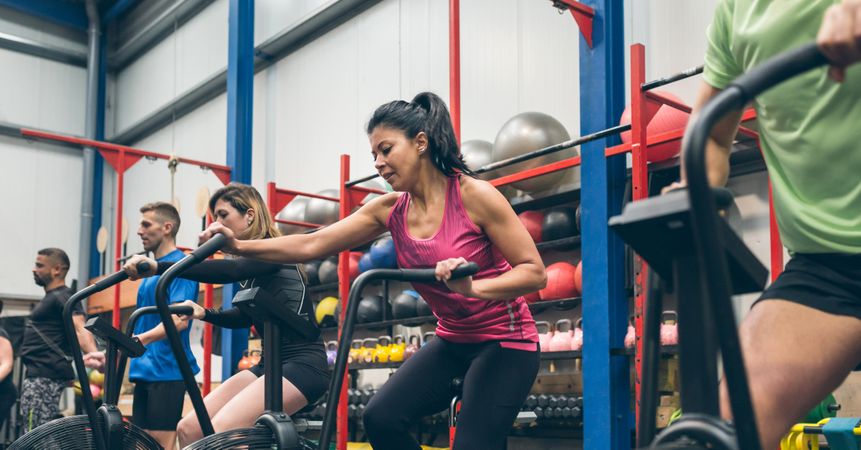 Athletes doing air bike indoor