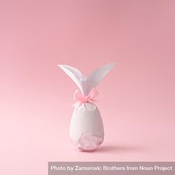 Egg wrapped in light  paper in Easter bunny shape 5nk324