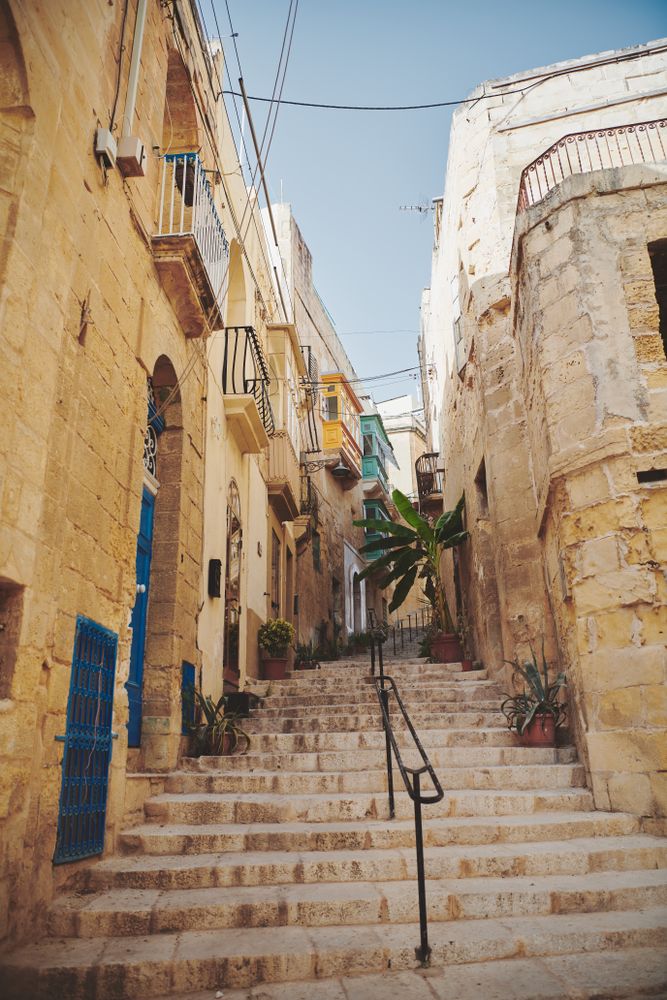 Stair walkway in Valetta with pots of plants from residents