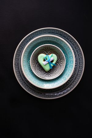Table setting with ornate plates and green heart