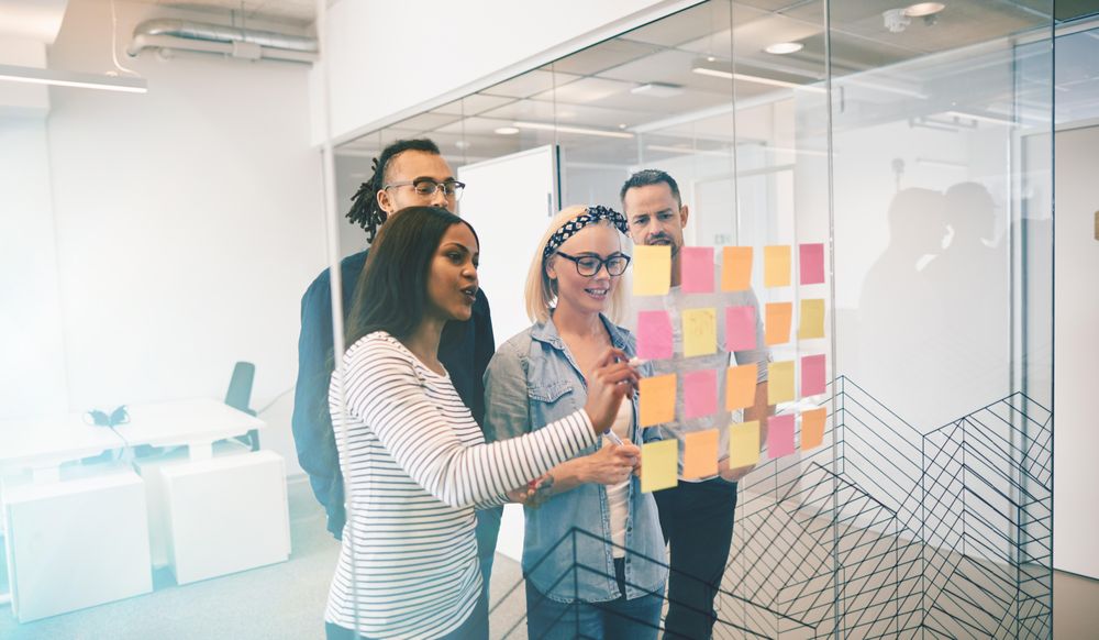 A corporate team brainstorming together in a bright modern office
