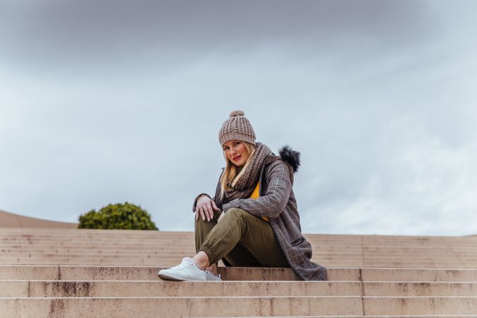 Blonde woman posing near the stairs