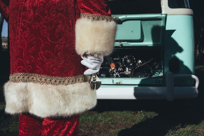 Santa Claus repairing old van
