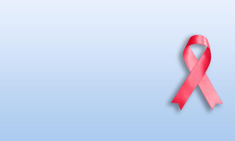 Pink ribbon on baby blue background