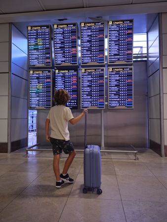 Unrecognizable boy in airport terminal