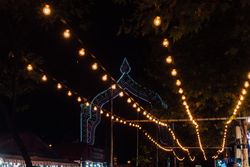 Illumination garlands on fairground at night