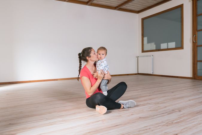 Woman holding baby in gym
