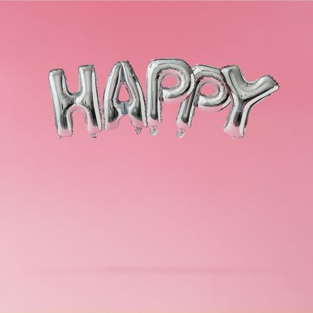Silver party balloons with “Happy” text on pink background