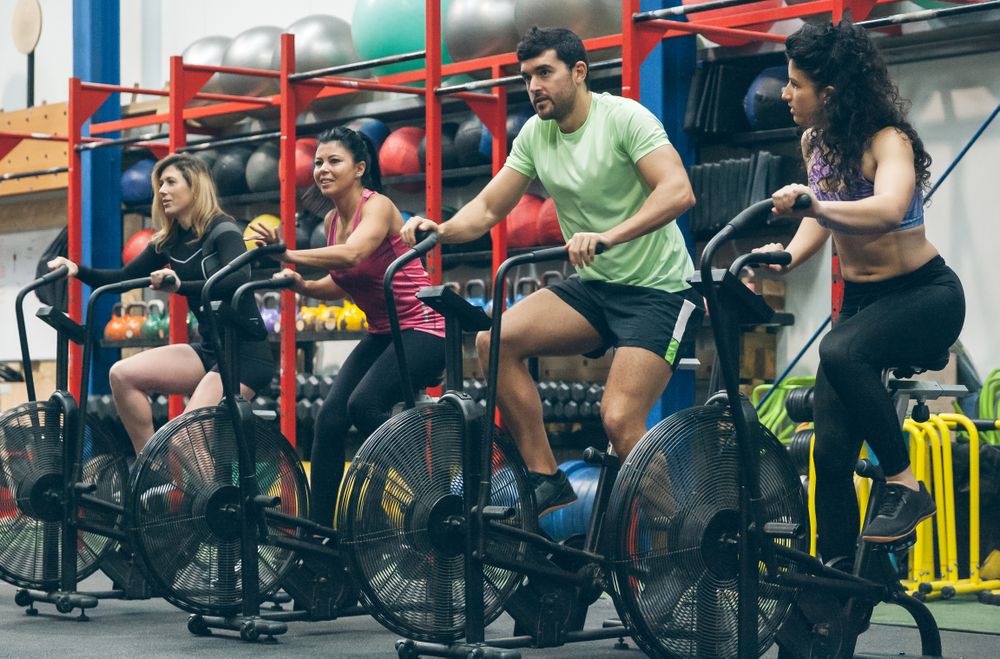 Athletes doing air bike indoor