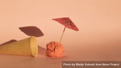 Ice cream cone with ice cream scoop with cocktail parasol bYla94