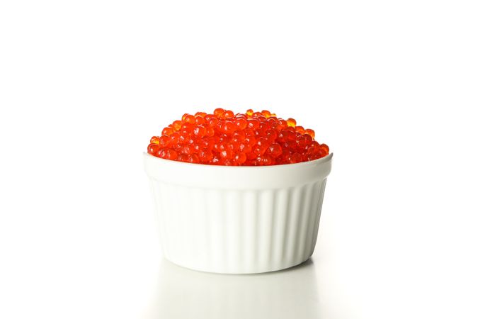 Small bowl with caviar isolated on plain background