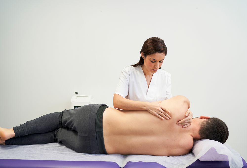 physiotherapist treating the patient's shoulder