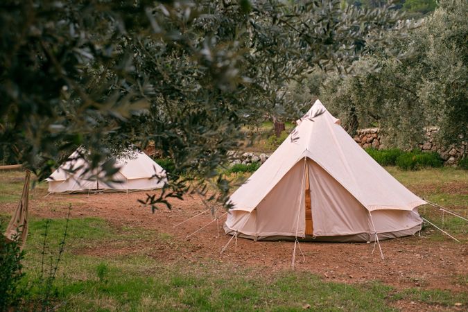 Tent fixed on ground in campsite in countryside