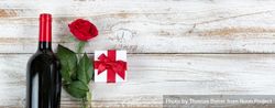 Valentine’s Day celebration with red wine and gifts rose on rustic wooden background 5q27p4