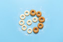 Homemade dough and deep-fried donuts, top view