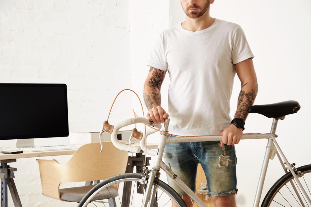 Man in big loft in front of his working desktop