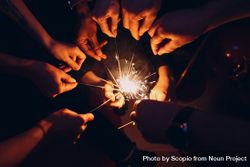 People holding lighted sparkler during nighttime 5axDA0