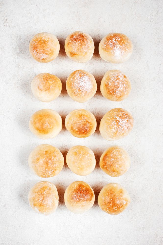 Freshly baked bread rolls in neat rows