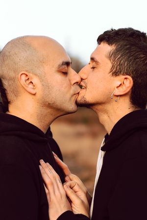 Men hugging and kissing n forest