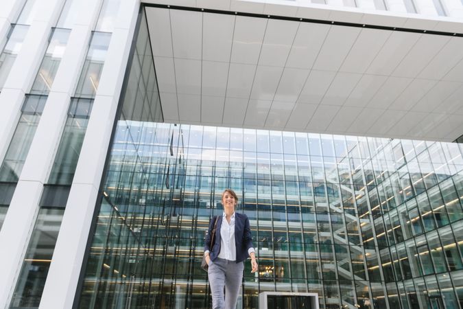 Happy female manager walking from work