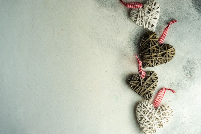 Top view of four heart shape decorations on marble counter