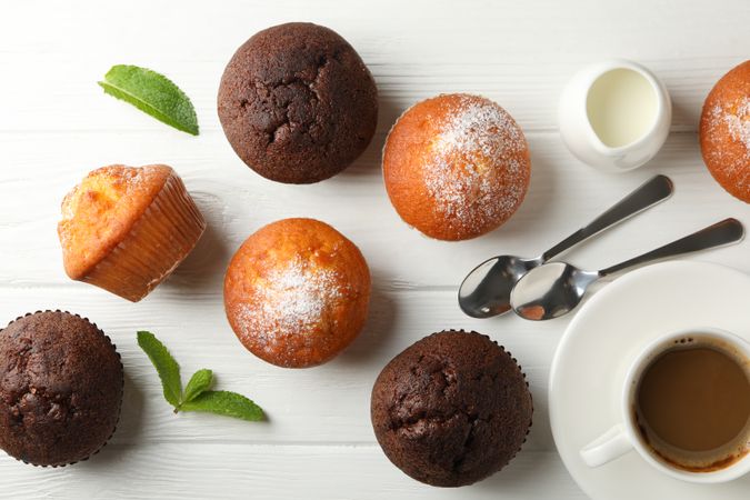 Composition with muffins and cocoa drink on wooden background